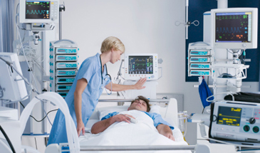 Doctor with patient in bed